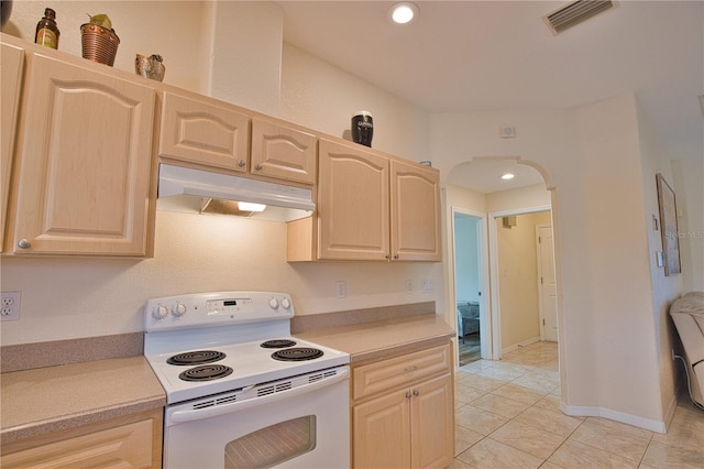 kitchen with white electric range, light brown cabinets, and light tile patterned floors