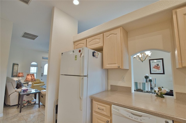 kitchen featuring light brown cabinetry, light tile patterned floors, and white appliances