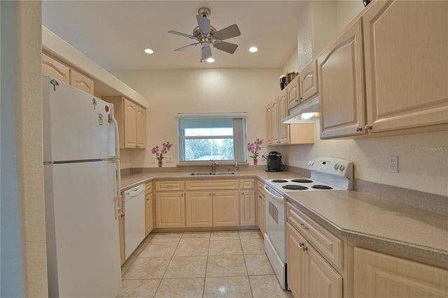 kitchen featuring light tile patterned flooring, white appliances, light brown cabinetry, and sink