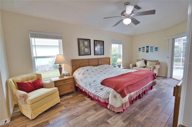 bedroom with access to outside, dark hardwood / wood-style floors, and ceiling fan