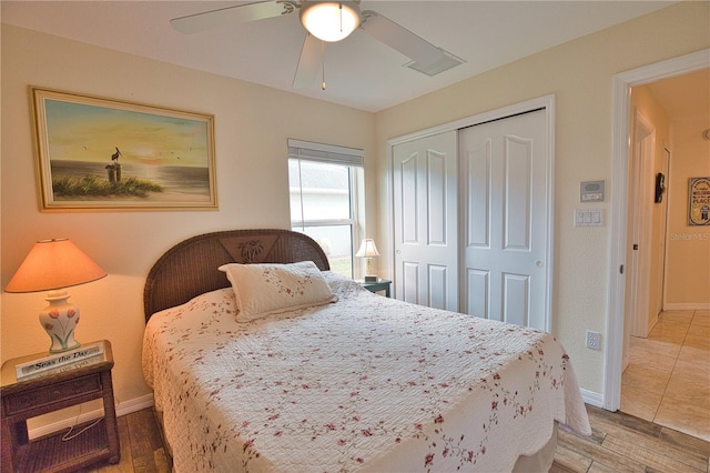 bedroom with hardwood / wood-style floors, a closet, and ceiling fan