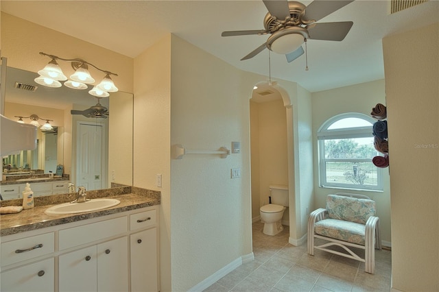 bathroom with vanity, ceiling fan, tile patterned floors, and toilet