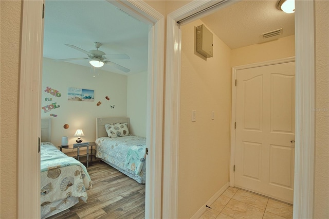 bedroom with ceiling fan and light wood-type flooring