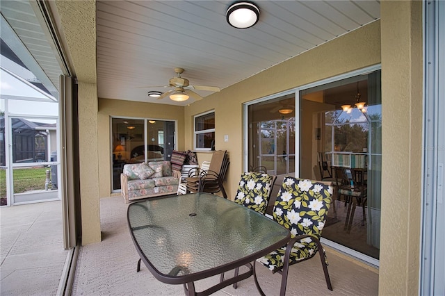 sunroom with a wealth of natural light and ceiling fan