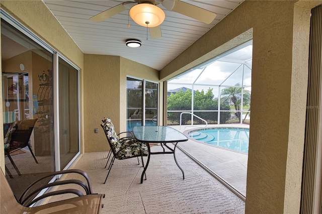 view of pool featuring glass enclosure and a patio area