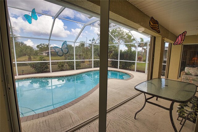 view of pool with a lanai and a patio