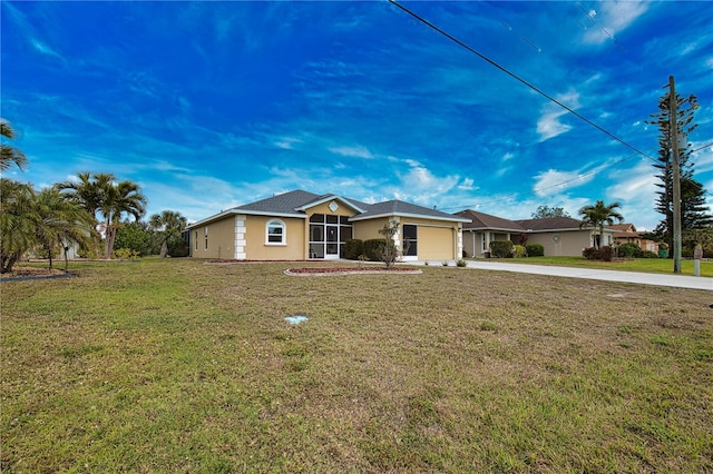 ranch-style home featuring a garage and a front lawn