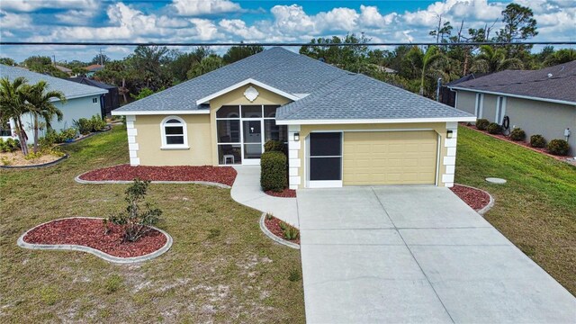 ranch-style house featuring a garage and a front lawn