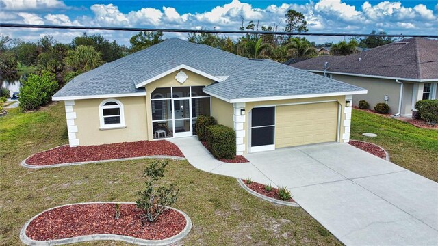 ranch-style home featuring a garage and a front lawn