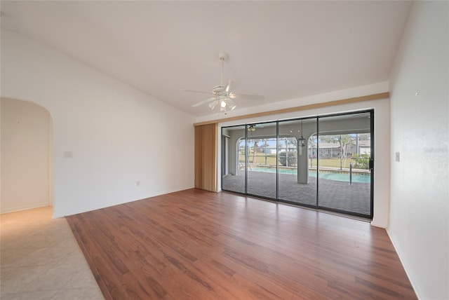 unfurnished room featuring vaulted ceiling, ceiling fan, and light hardwood / wood-style floors