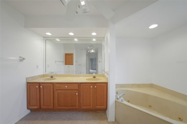 bathroom with vanity, tile patterned flooring, a bathtub, and ceiling fan