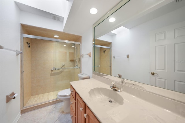 bathroom featuring an enclosed shower, vanity, tile patterned floors, and toilet