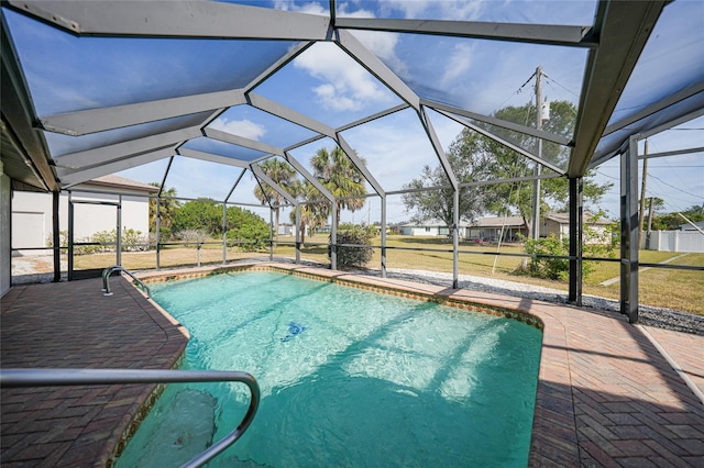 view of swimming pool with a patio and glass enclosure