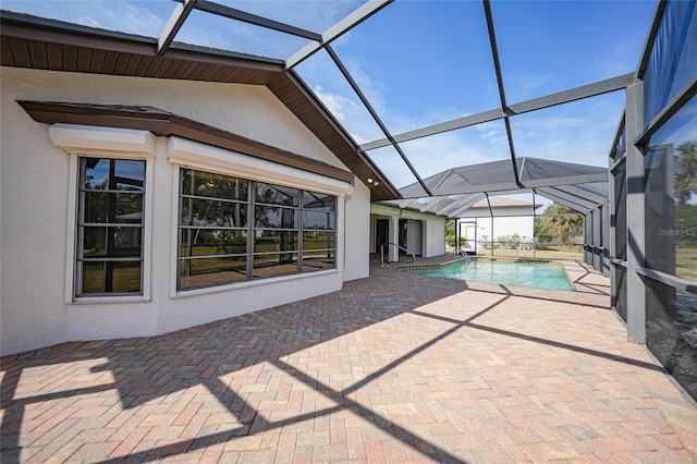 view of swimming pool featuring a patio and a lanai