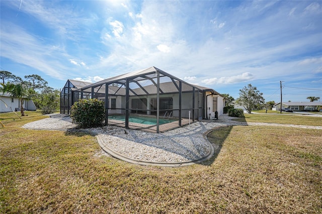 back of house with a yard and glass enclosure