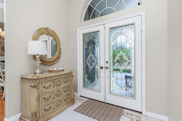 entrance foyer with light tile patterned floors and french doors