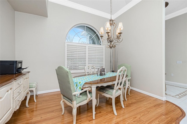 dining room with ornamental molding, a chandelier, and light wood-type flooring