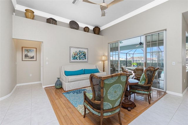 living room with hardwood / wood-style flooring, crown molding, and ceiling fan