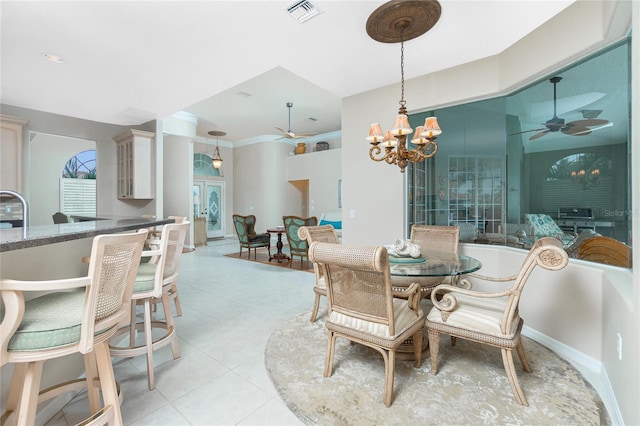 dining area featuring light tile patterned flooring and ceiling fan with notable chandelier