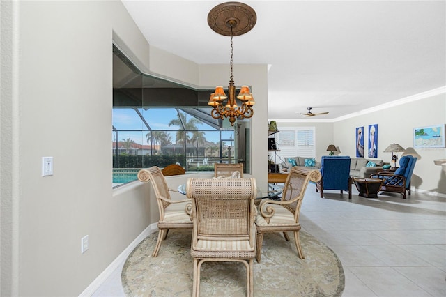 tiled dining space featuring ceiling fan with notable chandelier and ornamental molding