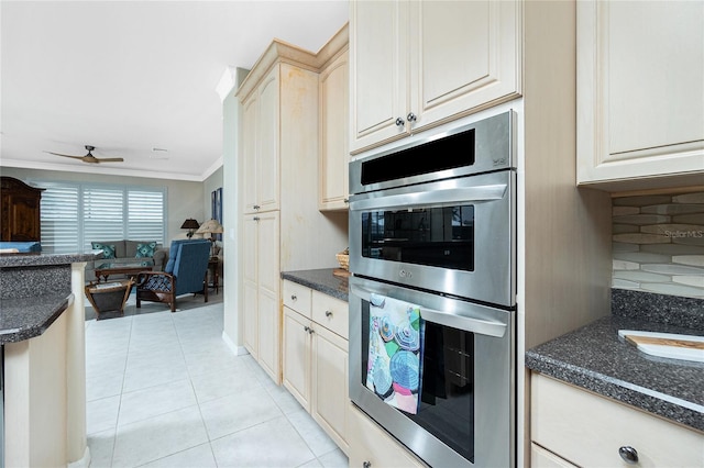 kitchen featuring light tile patterned flooring, crown molding, double oven, ceiling fan, and decorative backsplash