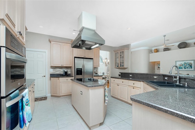 kitchen with sink, stainless steel appliances, island range hood, a kitchen island, and light brown cabinetry