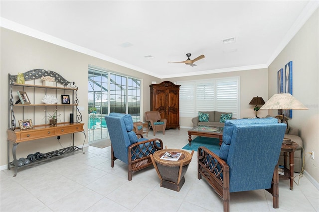 tiled living room featuring ornamental molding and ceiling fan