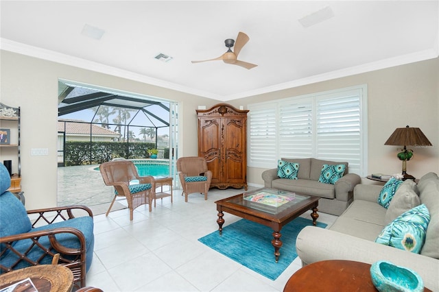 living room featuring light tile patterned floors, crown molding, and ceiling fan