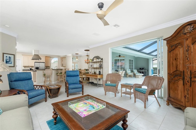 tiled living room featuring ceiling fan and ornamental molding