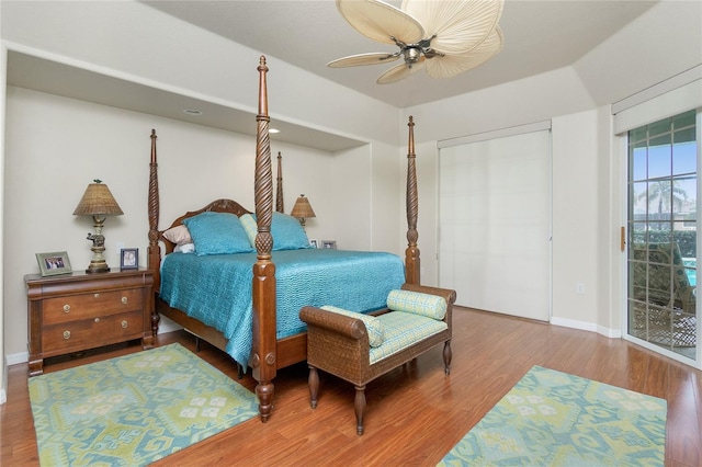 bedroom featuring access to exterior, hardwood / wood-style flooring, and ceiling fan