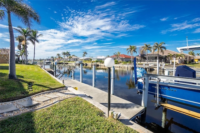 dock area featuring a water view and a yard