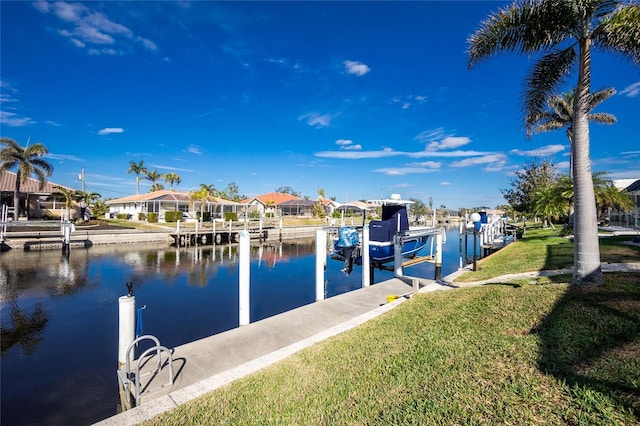 dock area featuring a water view and a lawn