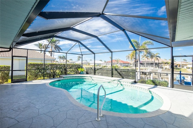 view of swimming pool featuring a lanai and a patio area