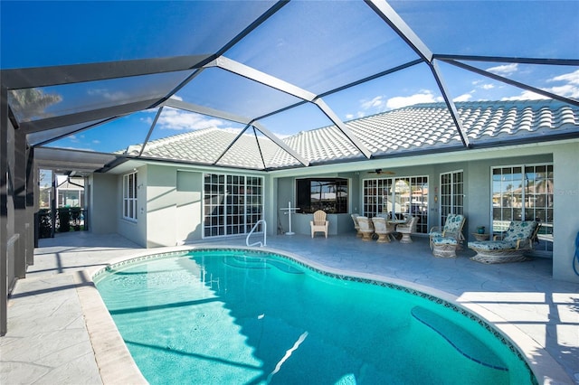 view of swimming pool with a patio area and glass enclosure