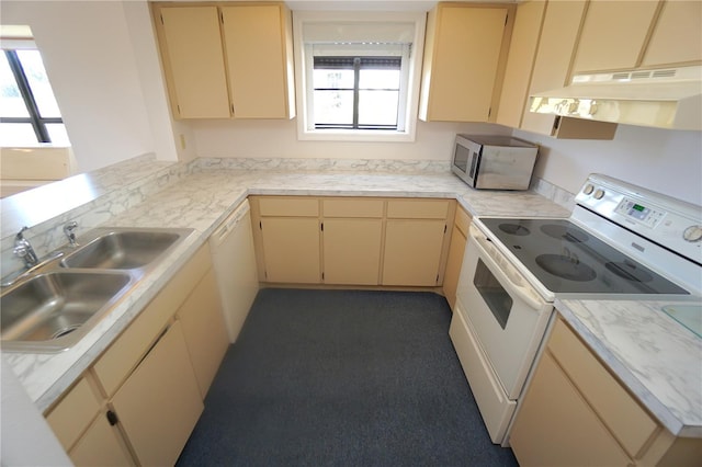 kitchen with sink, light brown cabinets, white appliances, and kitchen peninsula