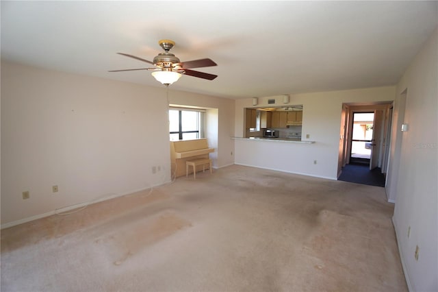 unfurnished living room with light carpet and ceiling fan