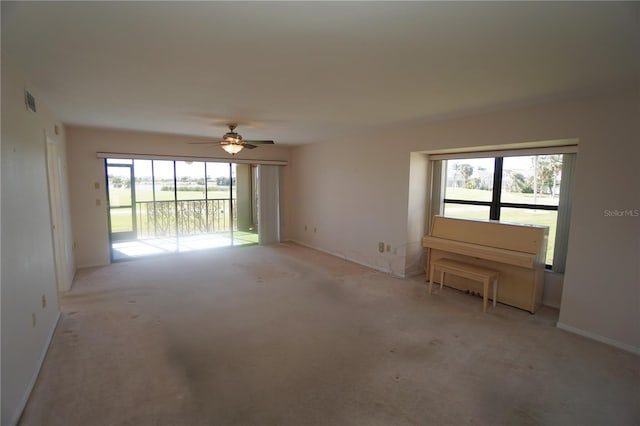 unfurnished room featuring light colored carpet and ceiling fan