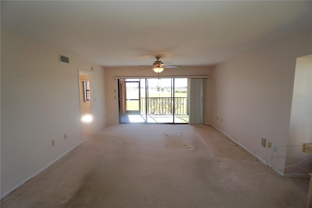 spare room with light carpet and ceiling fan