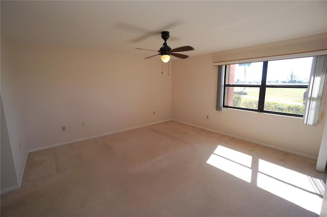 empty room featuring light carpet and ceiling fan