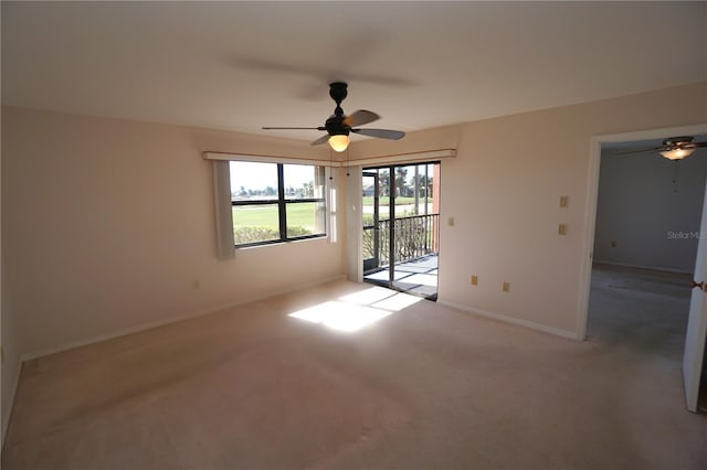 carpeted spare room featuring ceiling fan