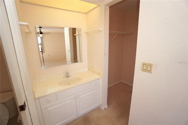 bathroom with vanity, ceiling fan, and toilet