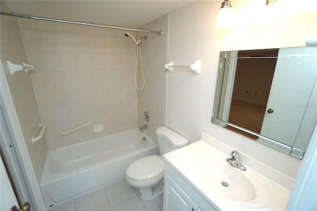 full bathroom with tiled shower / bath, tile patterned floors, toilet, and vanity