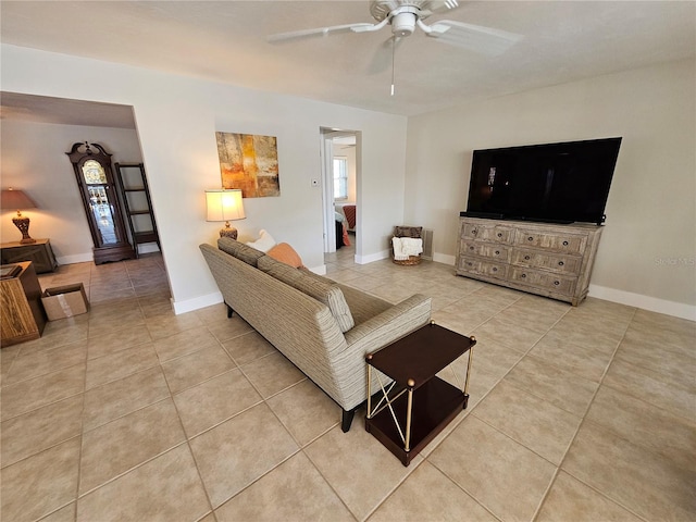 living room with light tile patterned floors and ceiling fan