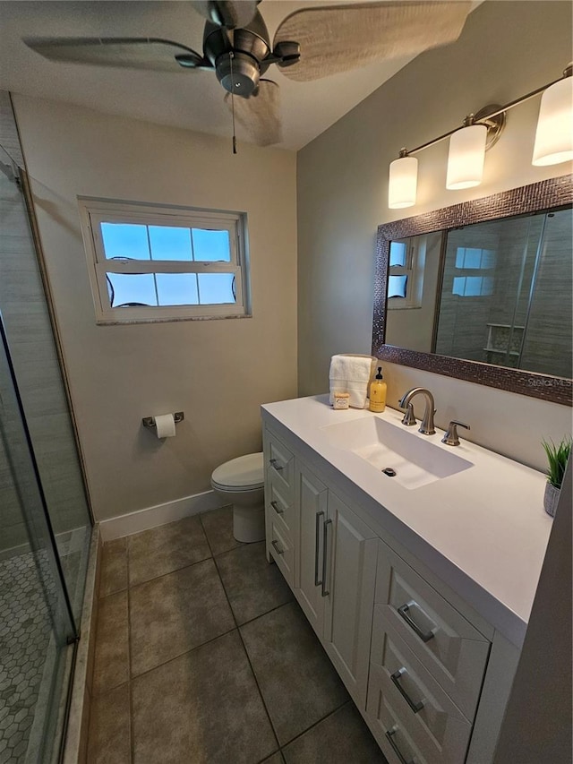 bathroom featuring ceiling fan, tile patterned flooring, vanity, toilet, and walk in shower