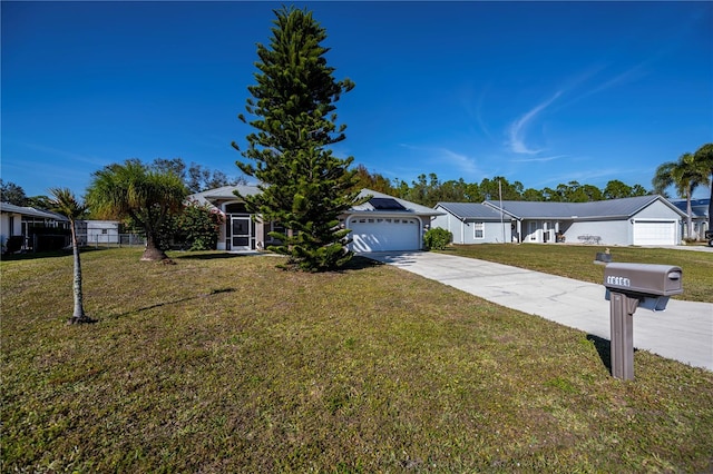 view of front of property featuring a garage and a front yard