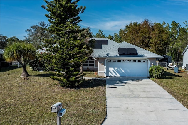 view of front of house featuring a garage and a front yard