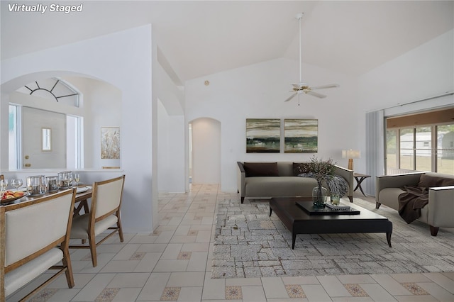 living room with high vaulted ceiling and ceiling fan