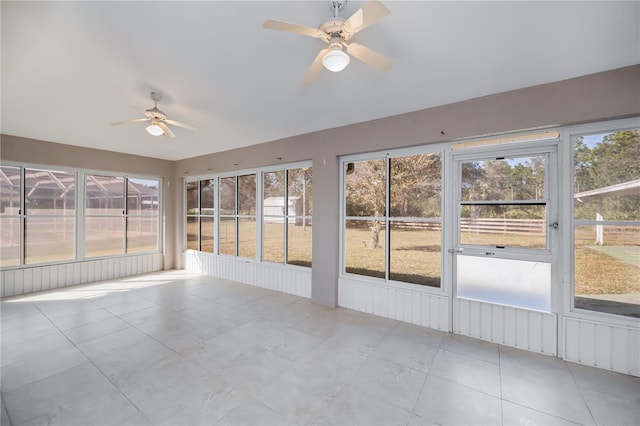 unfurnished sunroom with ceiling fan and a healthy amount of sunlight