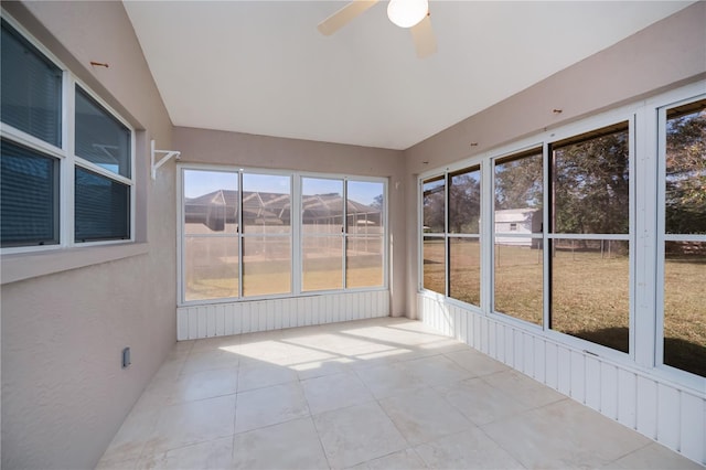 unfurnished sunroom featuring ceiling fan