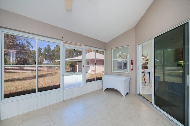 unfurnished sunroom featuring lofted ceiling